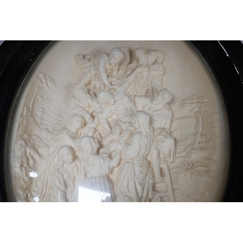 1288 - A pair of framed plaster ovals of the Madonna and Child with John the Baptist and the 'Descent from ... 