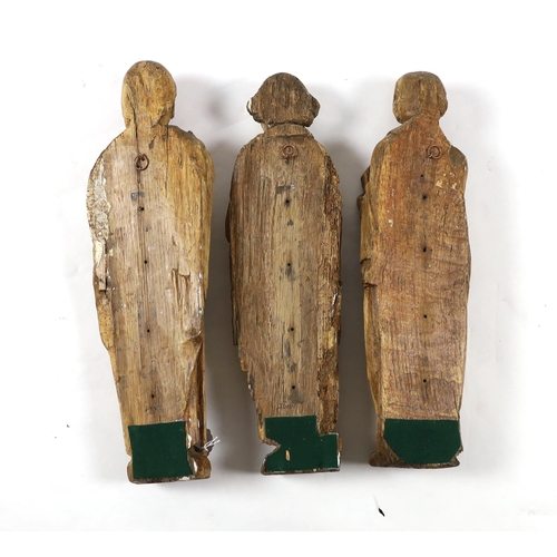 1356 - A set of three 18th century Continental carved wood figures of Saints, holding a cross, a bible and ... 