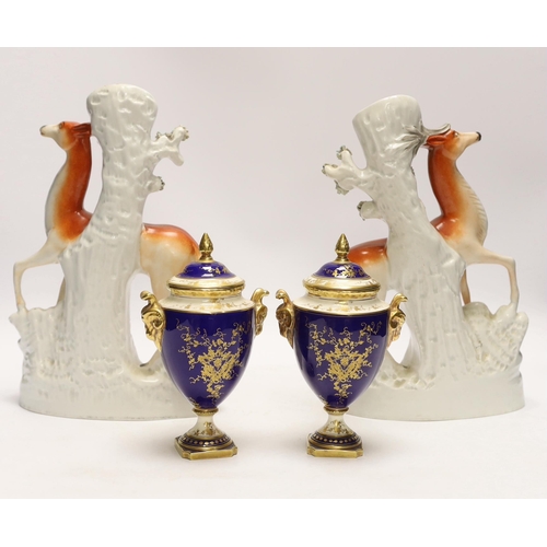 1422 - A pair of Coalport vases and covers and a pair of Staffordshire deer spill vases, largest 29cm high... 