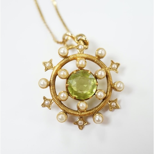 1956 - An Edwardian yellow metal, peridot and seed pearl cluster set 'wheel' pendant, overall 30mm, on a la... 