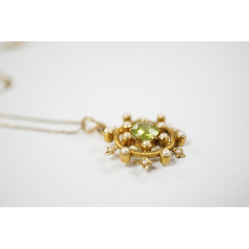 1956 - An Edwardian yellow metal, peridot and seed pearl cluster set 'wheel' pendant, overall 30mm, on a la... 