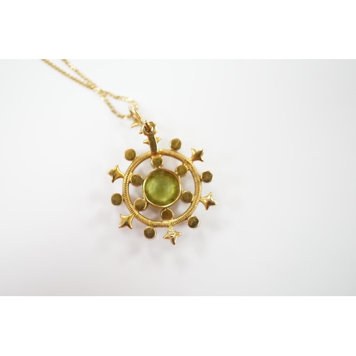 1956 - An Edwardian yellow metal, peridot and seed pearl cluster set 'wheel' pendant, overall 30mm, on a la... 