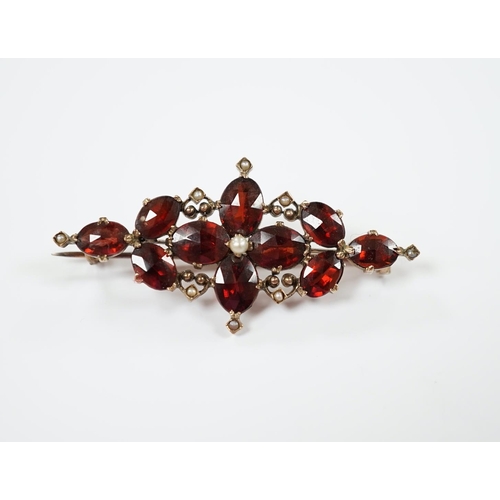 1957 - A Victorian yellow metal, garnet and seed pearl cluster set brooch, 44mm, gross weight 4.8 grams.... 