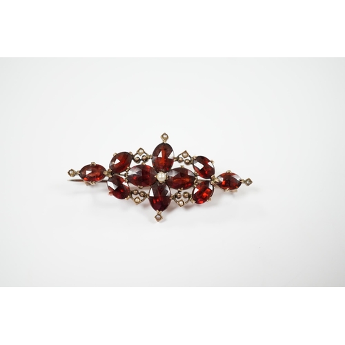 1957 - A Victorian yellow metal, garnet and seed pearl cluster set brooch, 44mm, gross weight 4.8 grams.... 