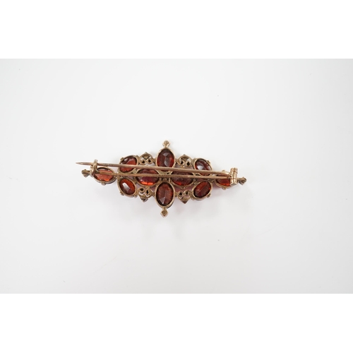 1957 - A Victorian yellow metal, garnet and seed pearl cluster set brooch, 44mm, gross weight 4.8 grams.... 