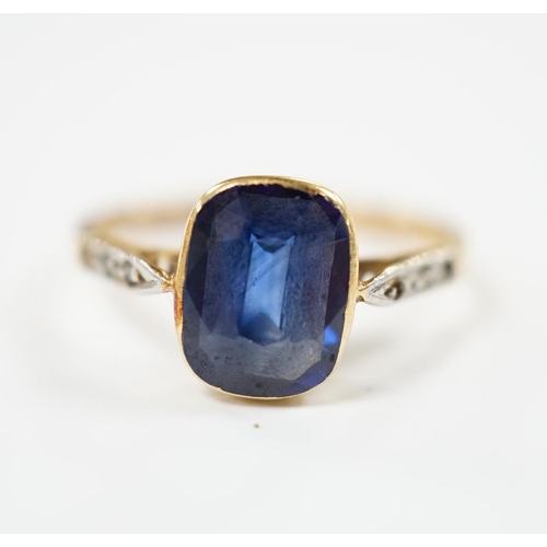 1958 - A yellow metal and single stone synthetic sapphire set ring, with rose cut diamond chip set shoulder... 