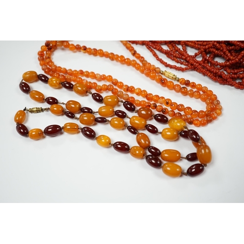 1987 - A single strand amber and simulated cherry amber bead necklace, 72cm, gross weight 33 grams, togethe... 