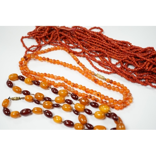 1987 - A single strand amber and simulated cherry amber bead necklace, 72cm, gross weight 33 grams, togethe... 