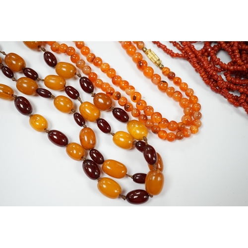 1987 - A single strand amber and simulated cherry amber bead necklace, 72cm, gross weight 33 grams, togethe... 