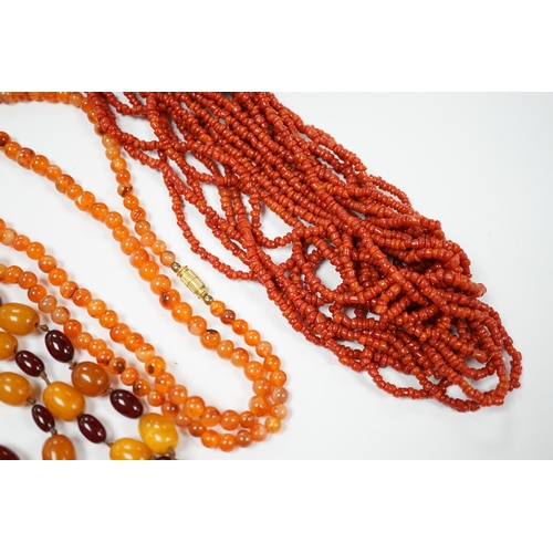 1987 - A single strand amber and simulated cherry amber bead necklace, 72cm, gross weight 33 grams, togethe... 