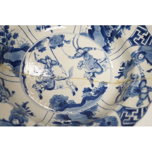 1282 - A Chinese blue and white warriors bowl, Kangxi mark and period, a similar hunting saucer dish, a... 