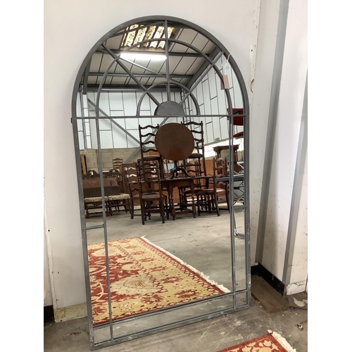 1022 - A large industrial style metal mounted arched garden window frame wall mirror, width 90cm, height 15... 