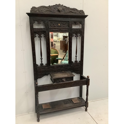 1023 - A late Victorian carved oak hallstand, width 107cm, height 210cm