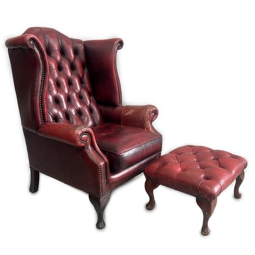 1043 - A Victorian style leather armchair, width 82cm, depth 80cm, height 110cm and footstool