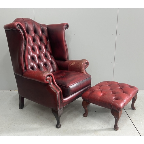 1043 - A Victorian style leather armchair, width 82cm, depth 80cm, height 110cm and footstool