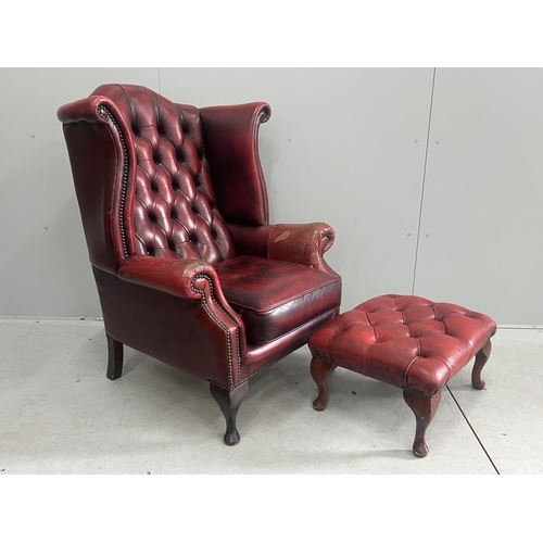 1043 - A Victorian style leather armchair, width 82cm, depth 80cm, height 110cm and footstool