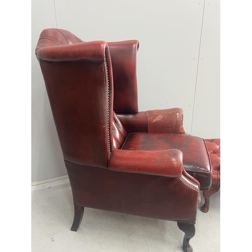 1043 - A Victorian style leather armchair, width 82cm, depth 80cm, height 110cm and footstool