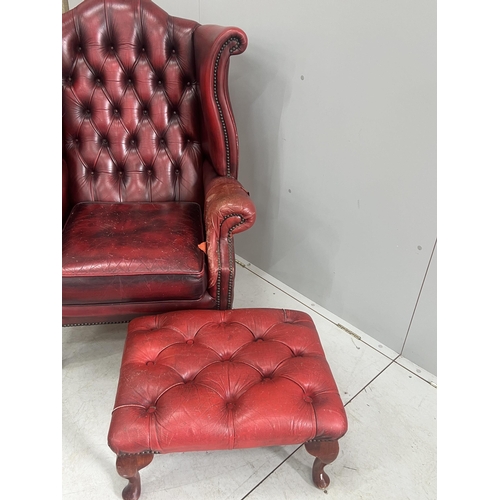 1043 - A Victorian style leather armchair, width 82cm, depth 80cm, height 110cm and footstool