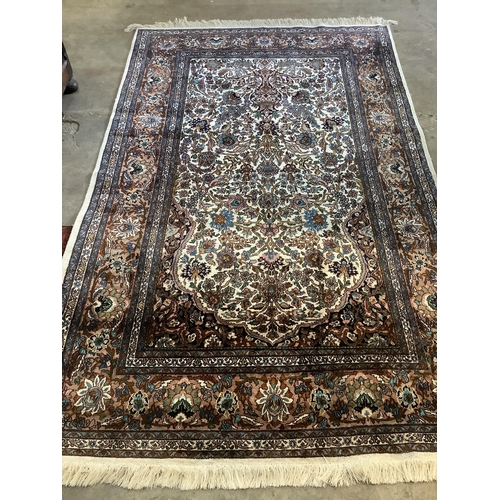 1056 - A North West Persian ivory ground rug, 220 x 136cm