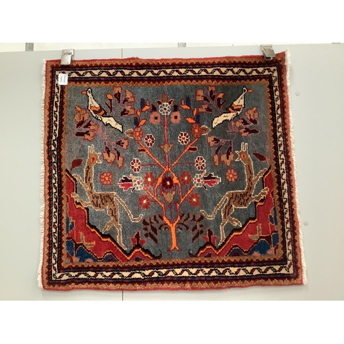 1075 - A Persian pictorial blue ground mat, 77 x 84cm