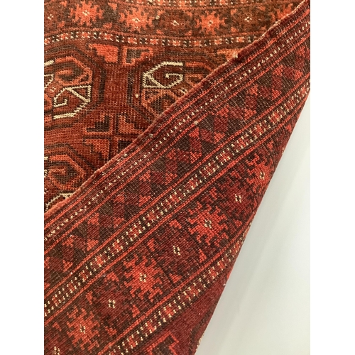 1080 - A Bokhara red ground rug, 100 x 72cm