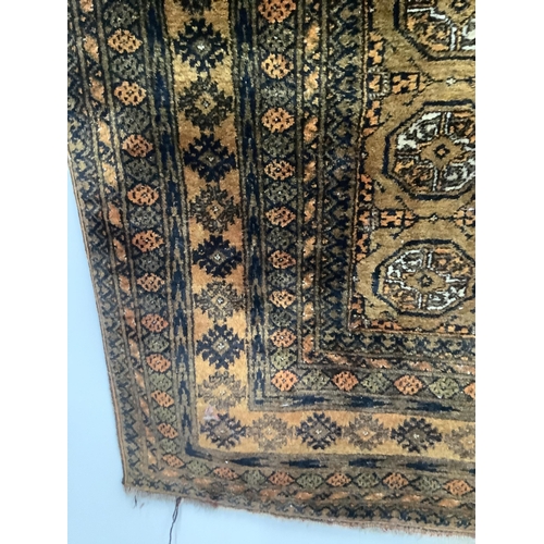 1099 - A Bokhara gold ground rug, 194 x 120cm