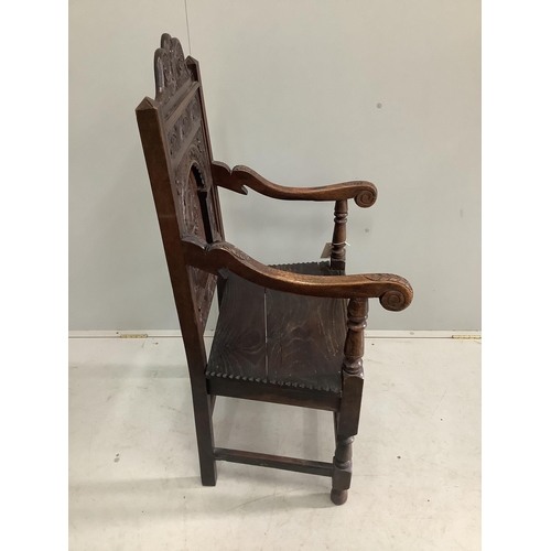 1140 - A 19th century oak panel back wainscot armchair, width 57cm, depth 54cm, height 117cm