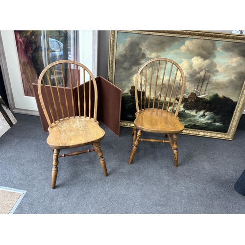 1212 - A set of six reproduction Windsor beech comb back dining chairs, two with arms