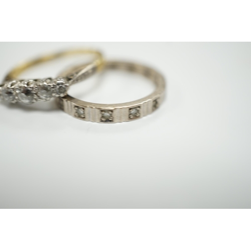 1947 - A 750 white metal and diamond chip set full eternity ring and an 18ct and graduated five stone diamo... 