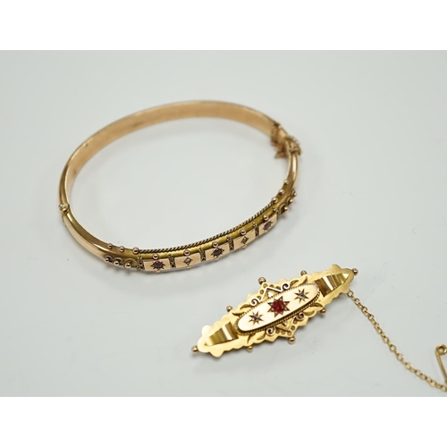 1950 - An Edwardian 9ct gold ruby and diamond chip set hinged bangle and a similar yellow metal, ruby and d... 