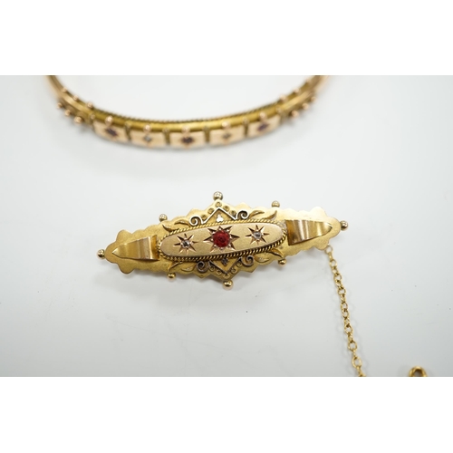 1950 - An Edwardian 9ct gold ruby and diamond chip set hinged bangle and a similar yellow metal, ruby and d... 