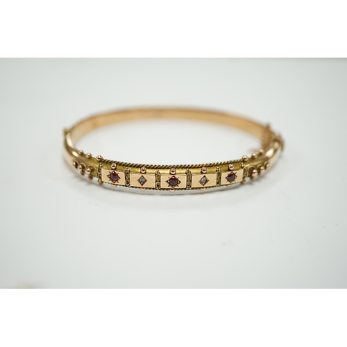 1950 - An Edwardian 9ct gold ruby and diamond chip set hinged bangle and a similar yellow metal, ruby and d... 