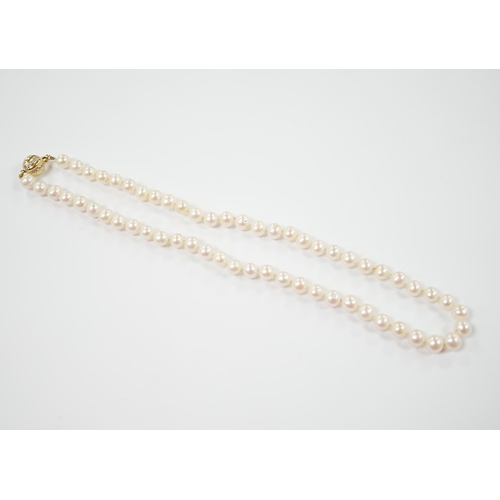 1953 - A single strand cultured pearl necklace with 18K and diamond chip set spherical clasp, 49cm.