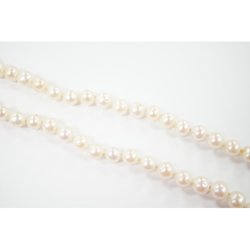 1953 - A single strand cultured pearl necklace with 18K and diamond chip set spherical clasp, 49cm.