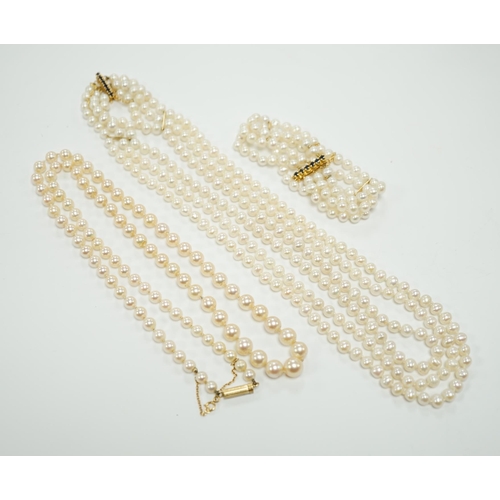 1956 - Two Cultured pearl necklaces including a triple strand with yellow metal and sapphire set clasp, 46c... 