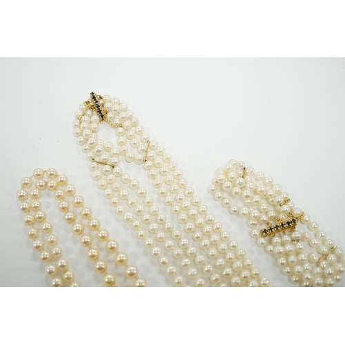 1956 - Two Cultured pearl necklaces including a triple strand with yellow metal and sapphire set clasp, 46c... 