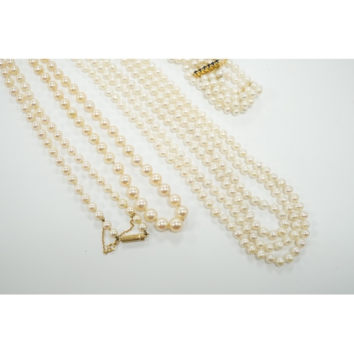 1956 - Two Cultured pearl necklaces including a triple strand with yellow metal and sapphire set clasp, 46c... 