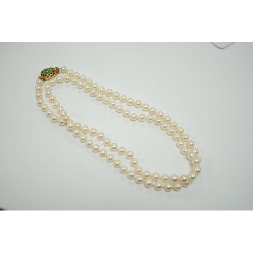 1957 - A single strand cultured pearl necklace, with 14k and jade set clasp, 40cm.