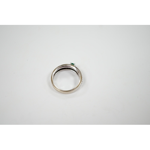 1979 - A modern 18ct white gold and single stone oval cut emerald set ring, with pave set diamond shoulders... 