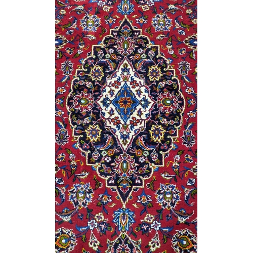 181 - A Tabriz burgundy ground carpet, 292 x 216cm