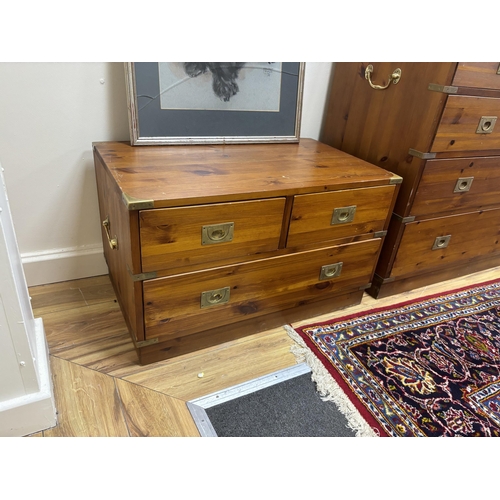 183 - A pair of military style brass mounted pine three drawer low chests, width 77cm, depth 46cm, height ... 