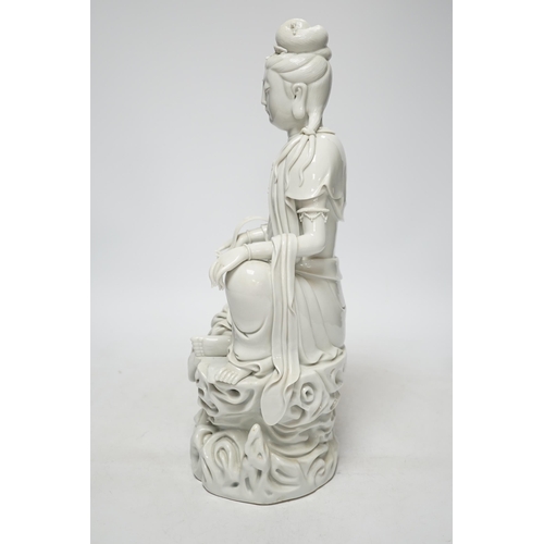 270 - A late 19th / early 20th century Chinese blanc de Chine seated figure of Guanyin, impressed mark to ... 