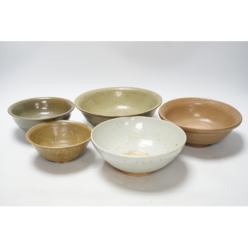 272 - A group of four Chinese Longquan or Yue ware celadon bowls and a Qingbai bowl, Song-Yuan dynasty, la... 