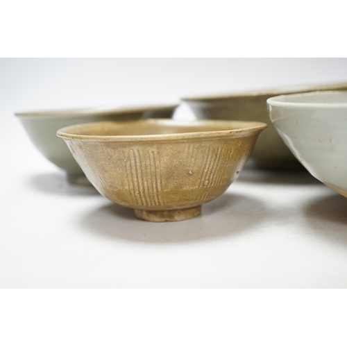 272 - A group of four Chinese Longquan or Yue ware celadon bowls and a Qingbai bowl, Song-Yuan dynasty, la... 