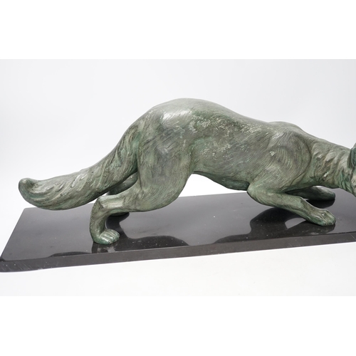 284 - A bronzed metal model of a stalking fox, on black marble plinth, 62cm