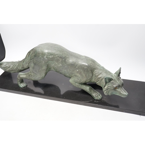 284 - A bronzed metal model of a stalking fox, on black marble plinth, 62cm