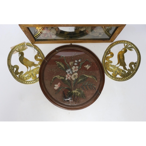 318 - A pair of oval brass crests, a circular framed Berlin beadwork panel and a framed floral wool work d... 