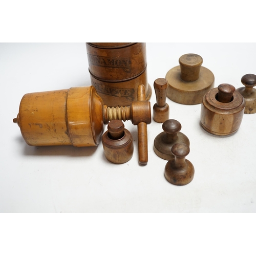 326 - Treen - a Victorian spice tower 18.5cm high, seven butter pats and a boxwood squeezer