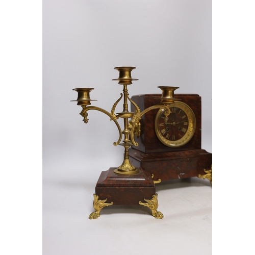 339 - A late 19th century French rouge marble and ormolu clock garniture, 31cm