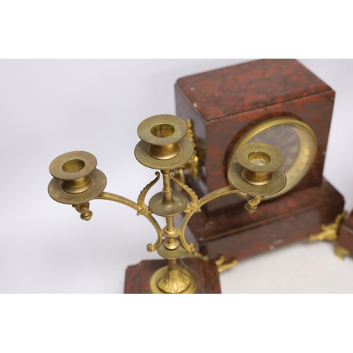 339 - A late 19th century French rouge marble and ormolu clock garniture, 31cm